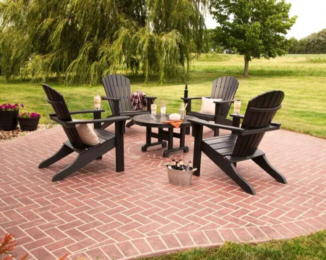 Black Adirondack Chairs on a Brick Patio