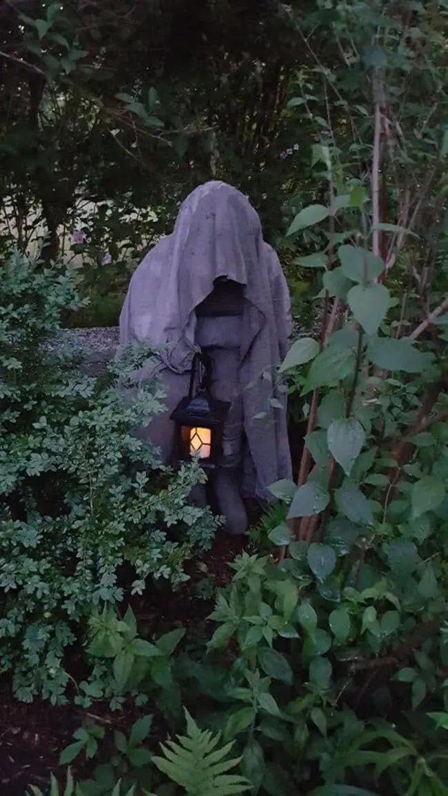 Mysterious Hooded Figure in the Garden for Eerie Vibes