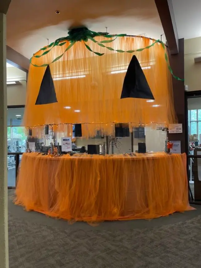 Giant Pumpkin Hanging Over Desk Area