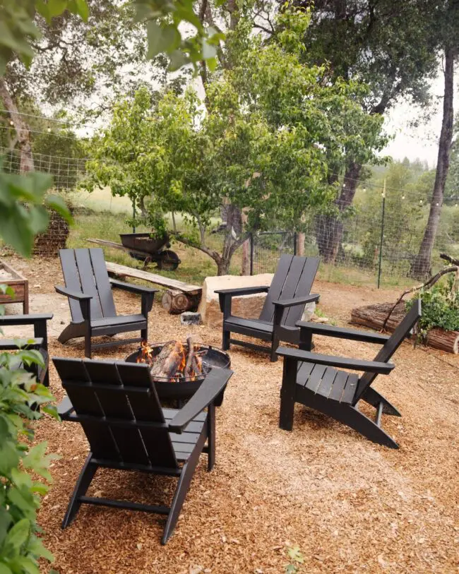 Black Adirondack Chairs in Countryside Surroundings